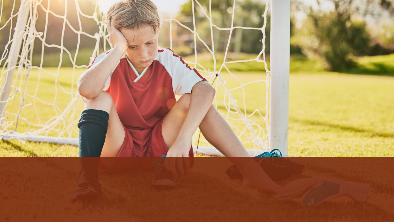 Sad Soccer Player Sitting on Bench